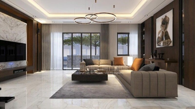 Nếu bạn thích một không gian nhẹ nhàng, bạn có thể tham khảo những mẫu thiết kế biệt thự tại Park City hoặc trên website thietkenoithat.com với những tấm ốp tường gỗ màu nâu và bộ sofa góc cùng màu.